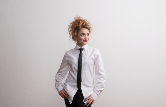 Young Beautiful Happy Woman In Studio, Wearing White Shirt And Black Tie.