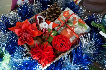 Fototapeta na wymiar Homemade Christmas decoration. Set of handmade fold paper red flower, blue garlands, figures, toys, gift box. Winter holidays and family tradition.