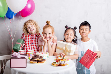 cheerful kids have gathered to celebrate a birthday. holiday concept.gifts from the hearts. wish concept