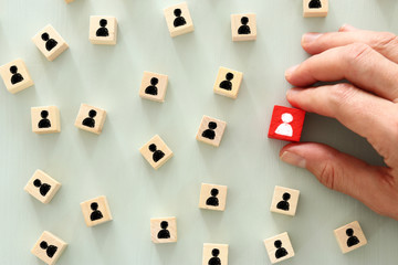 image of wooden blocks with people icons over mint table,building a strong team, human resources...