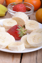 Close-up shot of variety of fruits on old wooden plate