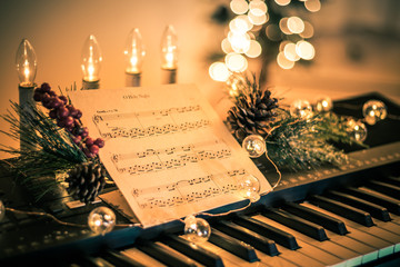 Keyboard with instrumental sheet music and soft lights for Christmas holiday, split tone © rabbitti