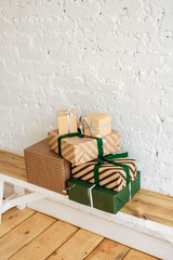 Christmas gift boxes on white brick wall background