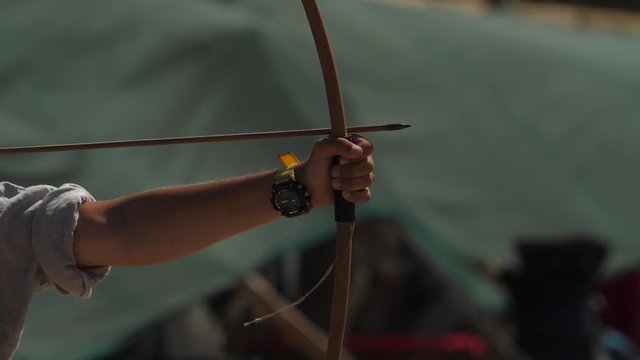 Hand of the archer pulls the bowstrings on the bow slow motion footage