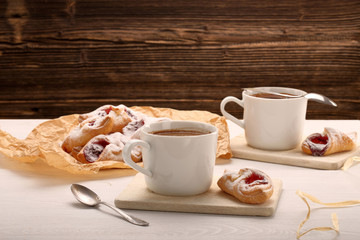 Fresh cup coffee served with small cake and empty space for text