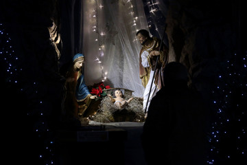 Christmas Nativity scene in the church, virgin Mary and Saint Joseph with Holy infant Jesus - obrazy, fototapety, plakaty
