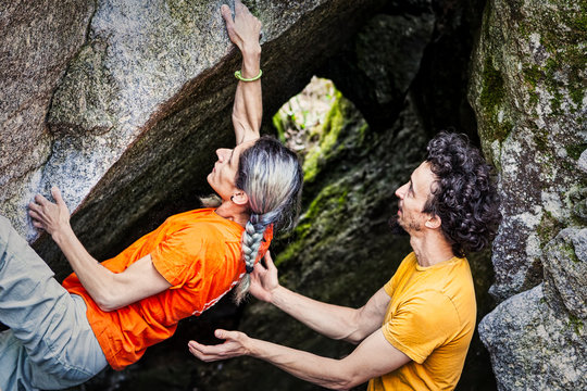 Climbers couple bouldering spotting