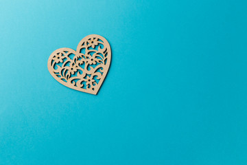 Valentine's Day postcard. Wooden heart on blue background. Copy space. Top view. Flat lay. Pastel colors