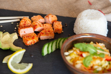 Poke bowls with salad and cucumber on the slate