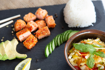 Poke bowls with salad and cucumber on the slate