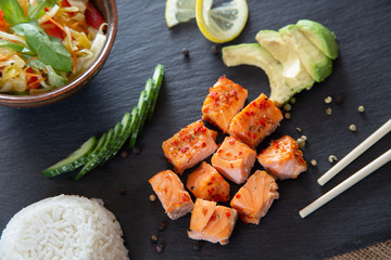 Poke bowls with salad and cucumber on the slate