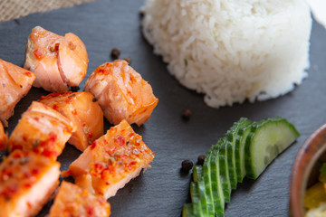 Poke bowls with salad and cucumber on the slate