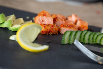 Poke bowls with salad and cucumber on the slate