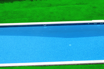 Swimming pool and grass aerial view.