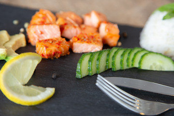 Poke bowls with salad and cucumber on the slate