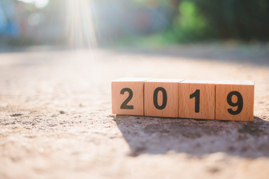 Wooden block year 2019 with sunlight background