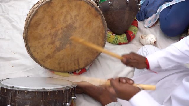 Man playing on a drum on time Pushkar Camel Mela near holy city Pushkar, Rajasthan, India, close up. Drums hands, movement, rhythm