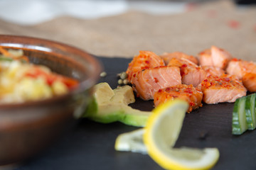 Poke bowls with salad and cucumber on the slate