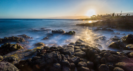Sunset at a rough Beach on Kauai Island, Hawaii