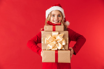 Pretty little girl wearing Christmas hat standing