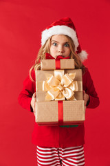 Pretty little girl wearing Christmas hat standing