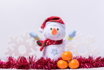 Funny snowman with big snowflakes from foam on a white background