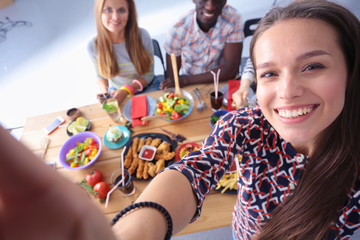 Group of people doing selfie during lunch. Self. Friends. Friends are photographed for eating