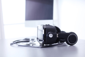 Virtual reality goggles on desk with laptop. business. 3d technology