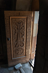 medieval cross stone door carved out of Tufa in Novarank monastery, armenia