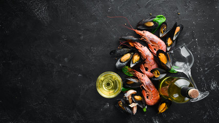 A bottle of wine and seafood. Top view. Free space for your text. On the old background.