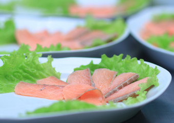 dishes with red fish on the table in the kitchen of the restaura