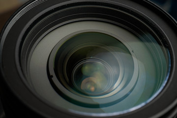 Close up of modern digital camera lense, a view of the front lens with flare effects