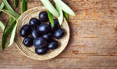 Dark olives on a wooden table