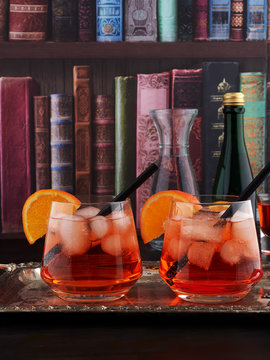 Two glasses of Aperol Spritz, an aperitif cocktail consisting of prosecco, Aperol and soda water, with ice cubes and orange slices