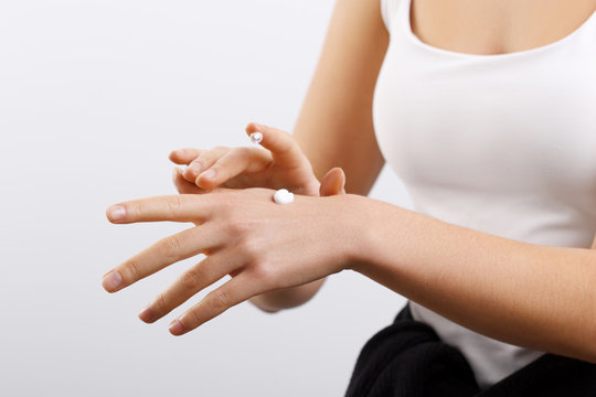 Hand Skin Care. Women use body lotion on your arms. Female applying cream to her hands