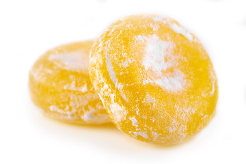Colored round candy in powdered sugar. Bright candy.