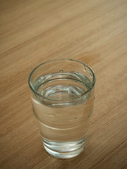 Glass water on wooden table