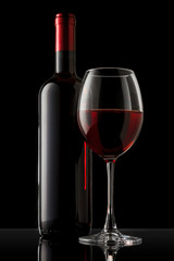 Red wine bottle and glass on the black background