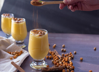 boza or bosa, a traditional Turkish drink roasted chickpeas and cinnamon on the brown table