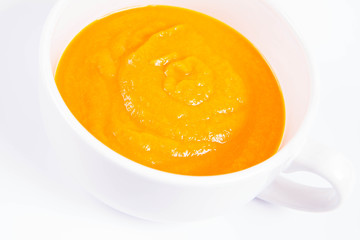 Pumpkin soup in a bowl on a white background