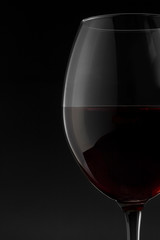 Red wine glass on the black background