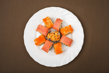 Top view of a portion of fresh sushi in a white plate