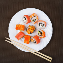 Portion of sushi in a white plate, top view © Sergey Chayko