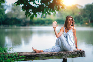 Yoga Woman by The Lake. Seated Spinal Twist