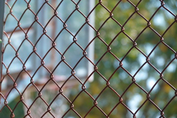 steel wire net fence with blurred green background