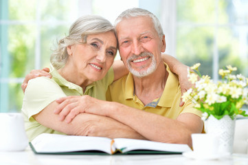 Portrait of senior couple with book drinking tea