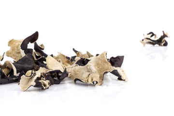 Lot of slices of dry black mushroom jew ear variety front focus isolated on white background