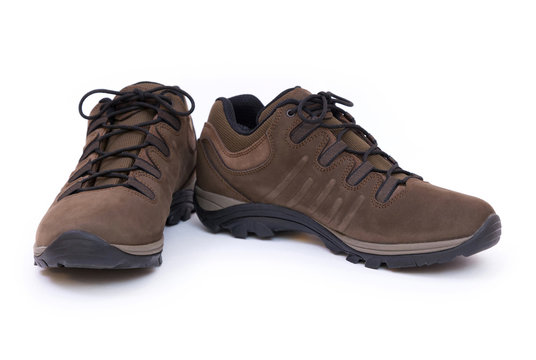 Closeup of a pair of brown unbranded trekking shoes isolated on white background