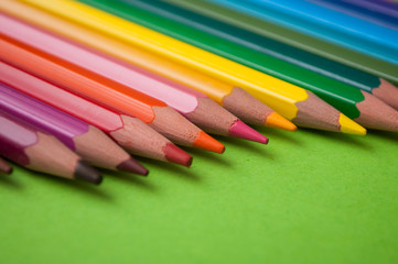 closeup of colouring pencils on green background