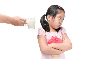 Sad girl refuses drink a fresh milk isolated